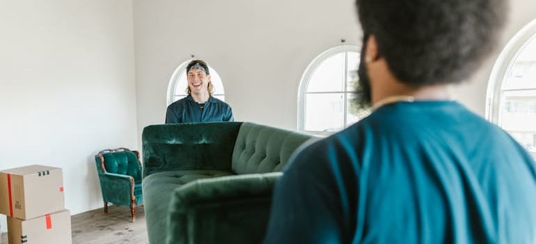 Two men carrying a couch