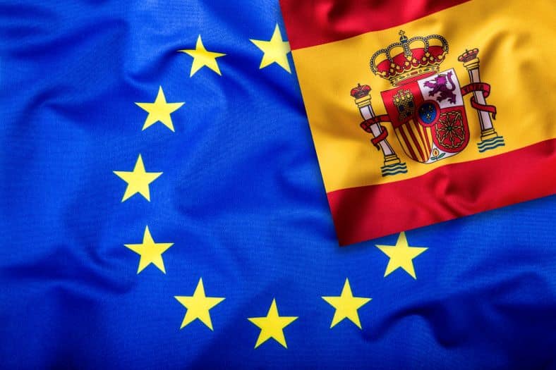 Close-up of the European Union and Spanish flags side by side, symbolizing Spain’s membership in the EU and the benefits it offers for those moving to Spain.