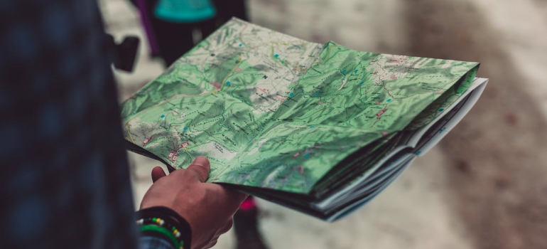 a man relocated from USA to Europe looking at the map 